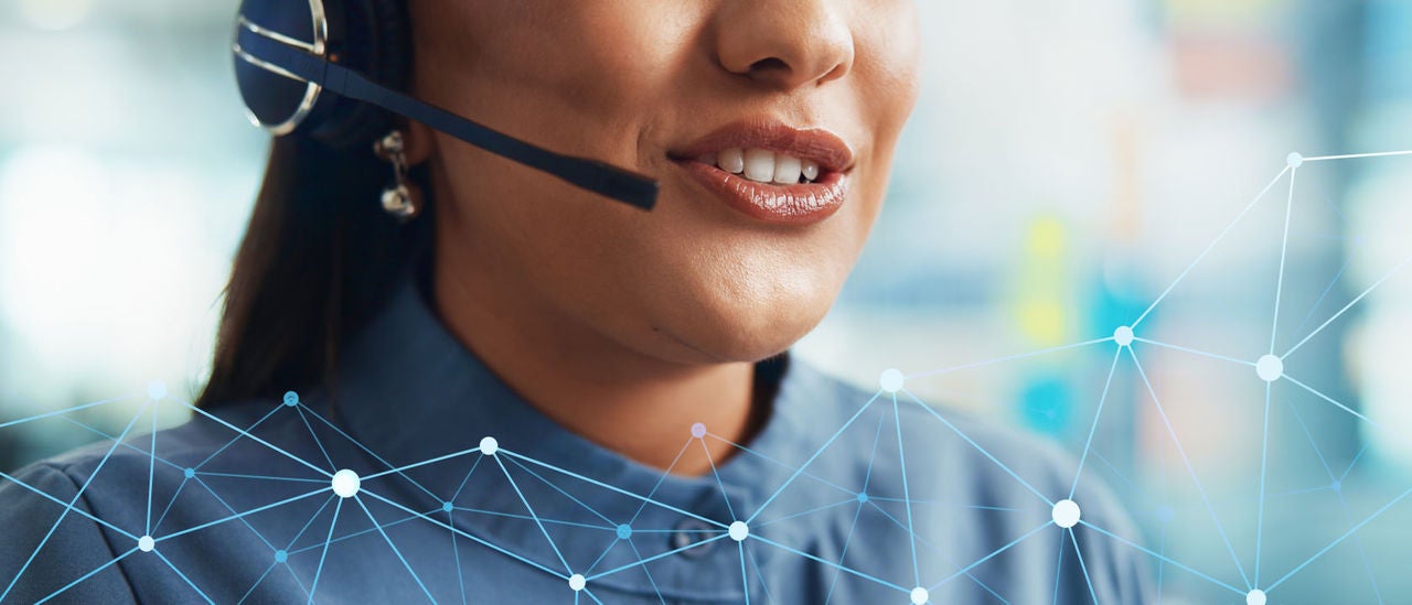 Close up of a call center worker's mouth while she's speaking into her headset