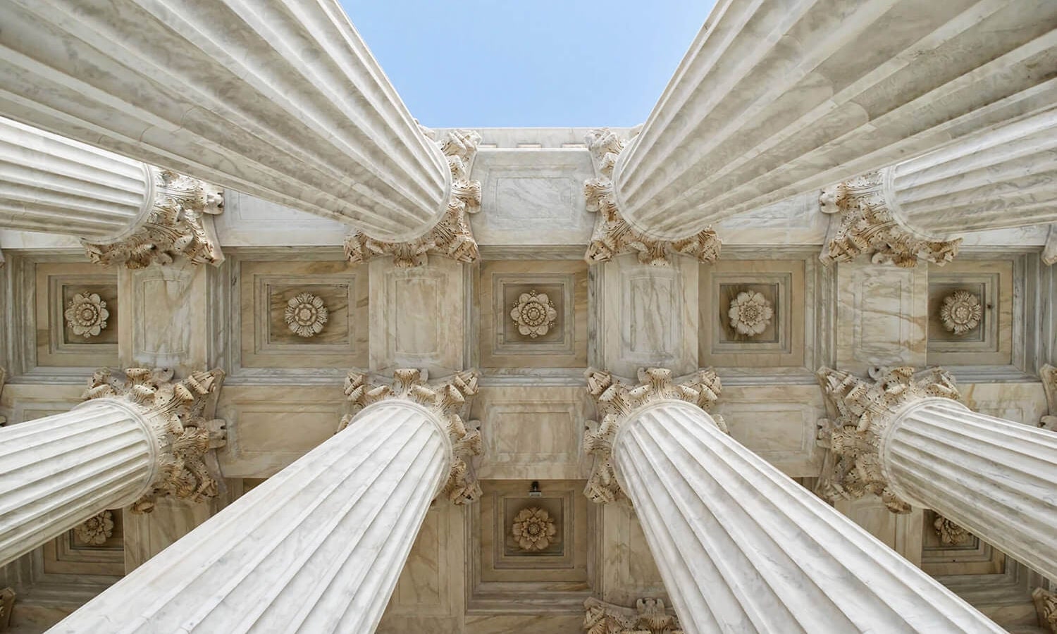 looking up at government building columns