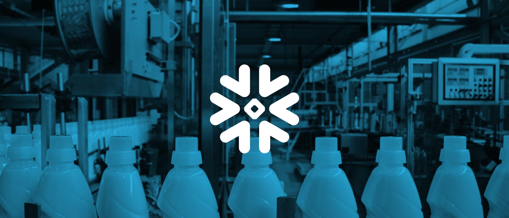 Close up of bottles on an assembly line in a factory.