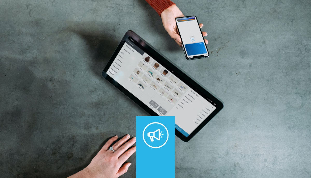 tablet sitting on a table and hand holding a phone