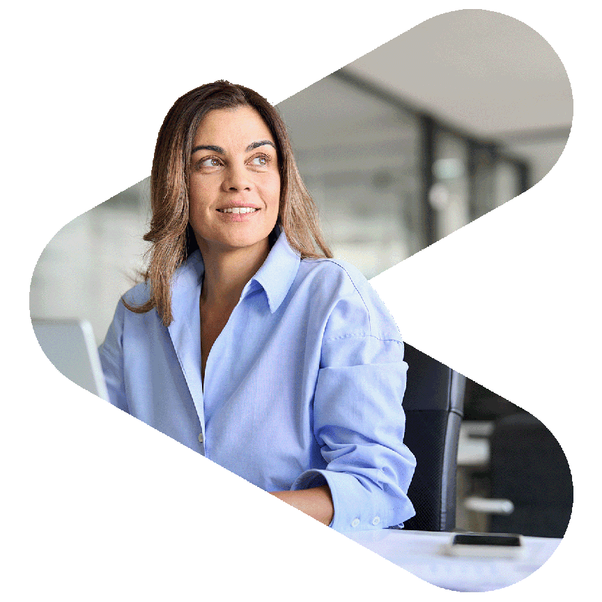 a woman sitting at a desk in front of a laptop