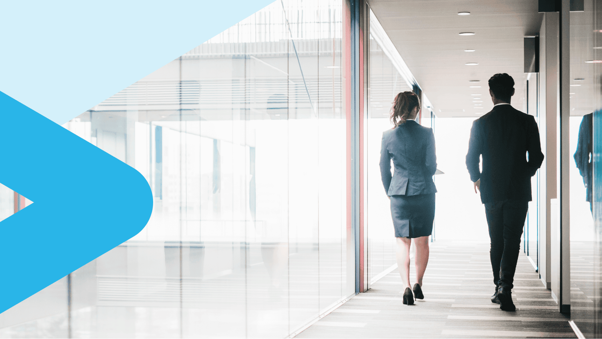 Two people walking in a hallway