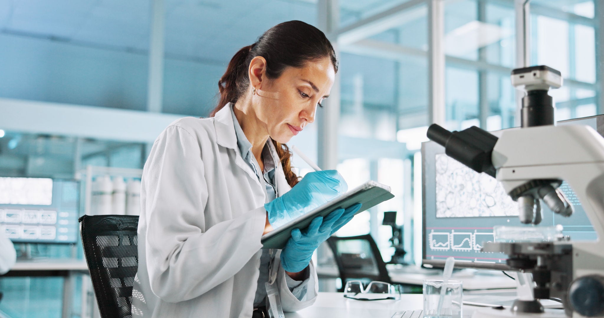 Researcher writing on her tablet