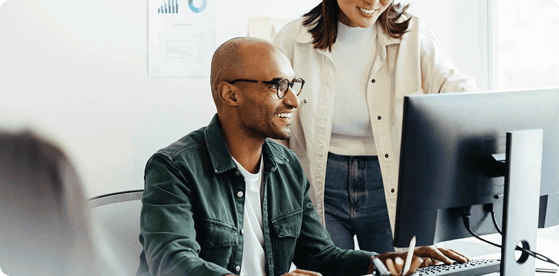 a person smiling looking at laptop
