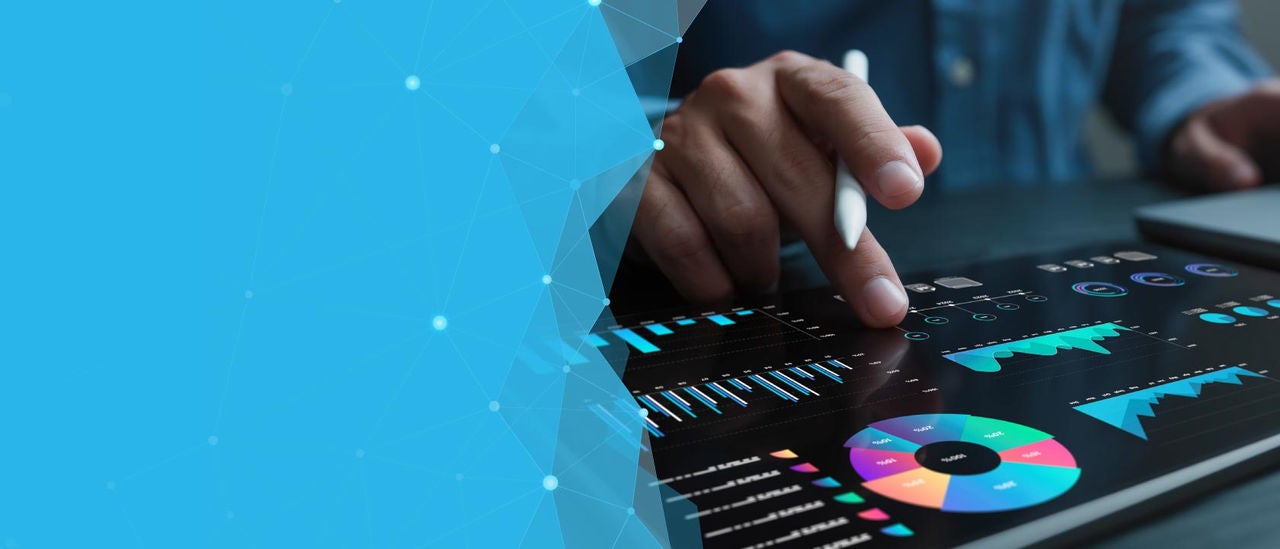 Close up of someone's hand touching a touch screen while holding a writing instrument.