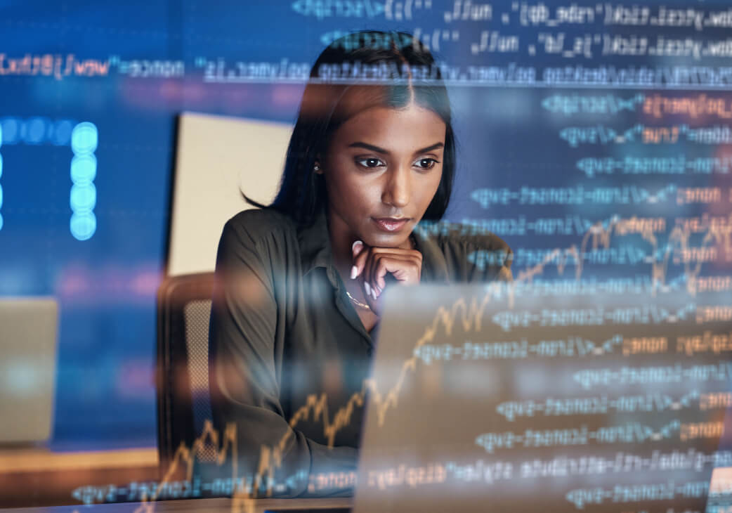 Data scientist working on code in her office