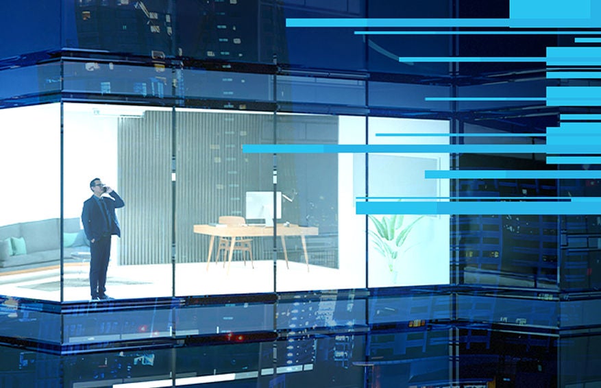 man standing in office building on the phone