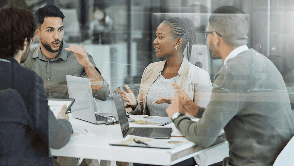 an image of people talking in a meeting room