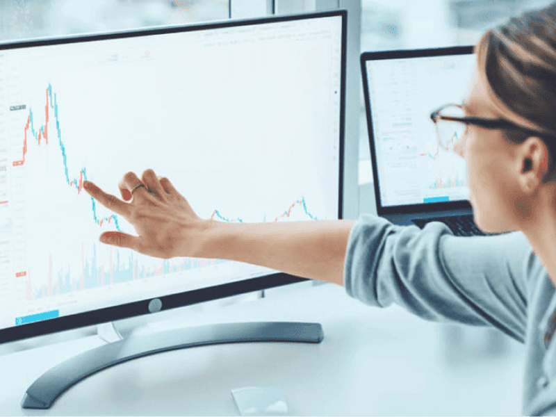 woman looking at data on monitor