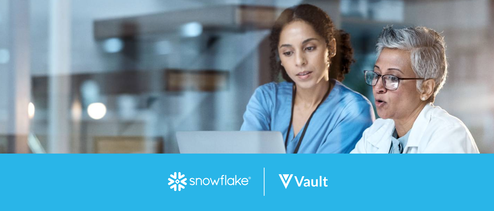 Two female healthcare workers looking at a laptop and talking, with a Snowflake and Vault logo lockup beneath them