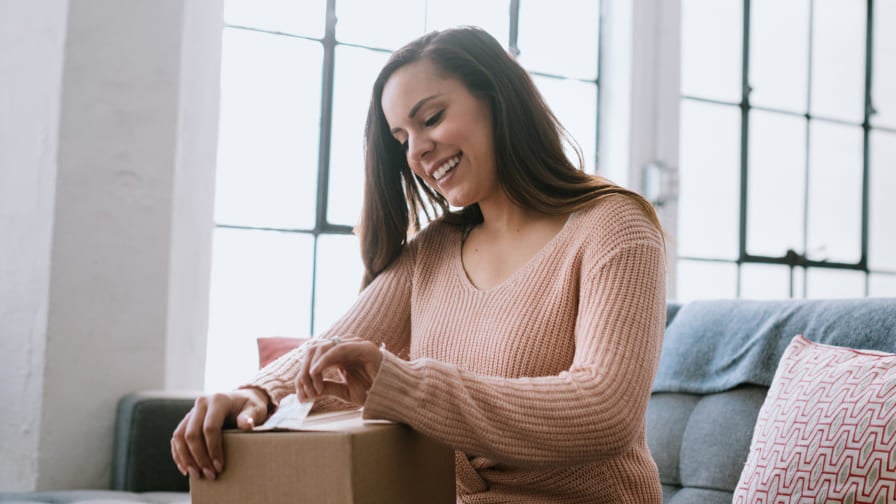 Woman sitting on sofa, windows in background