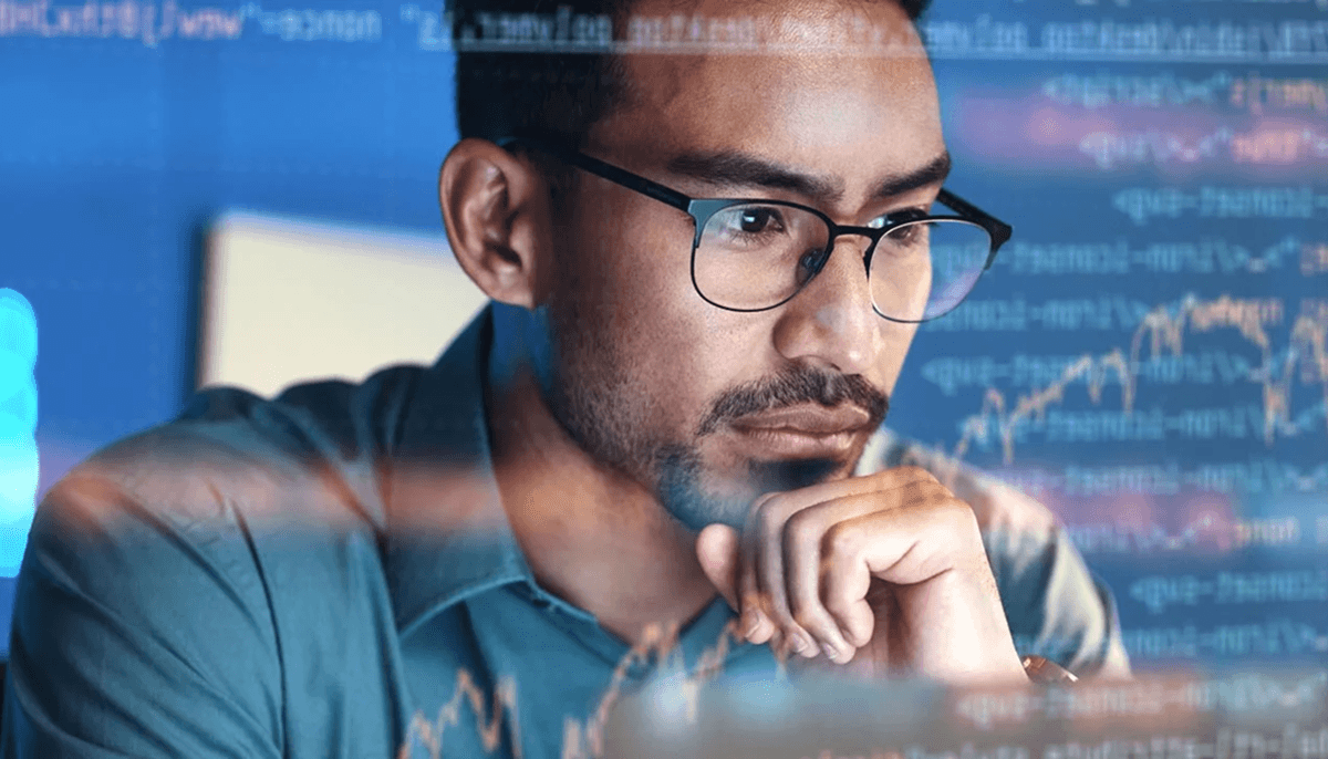 image of a man wearing glasses with a screen of code and data over him