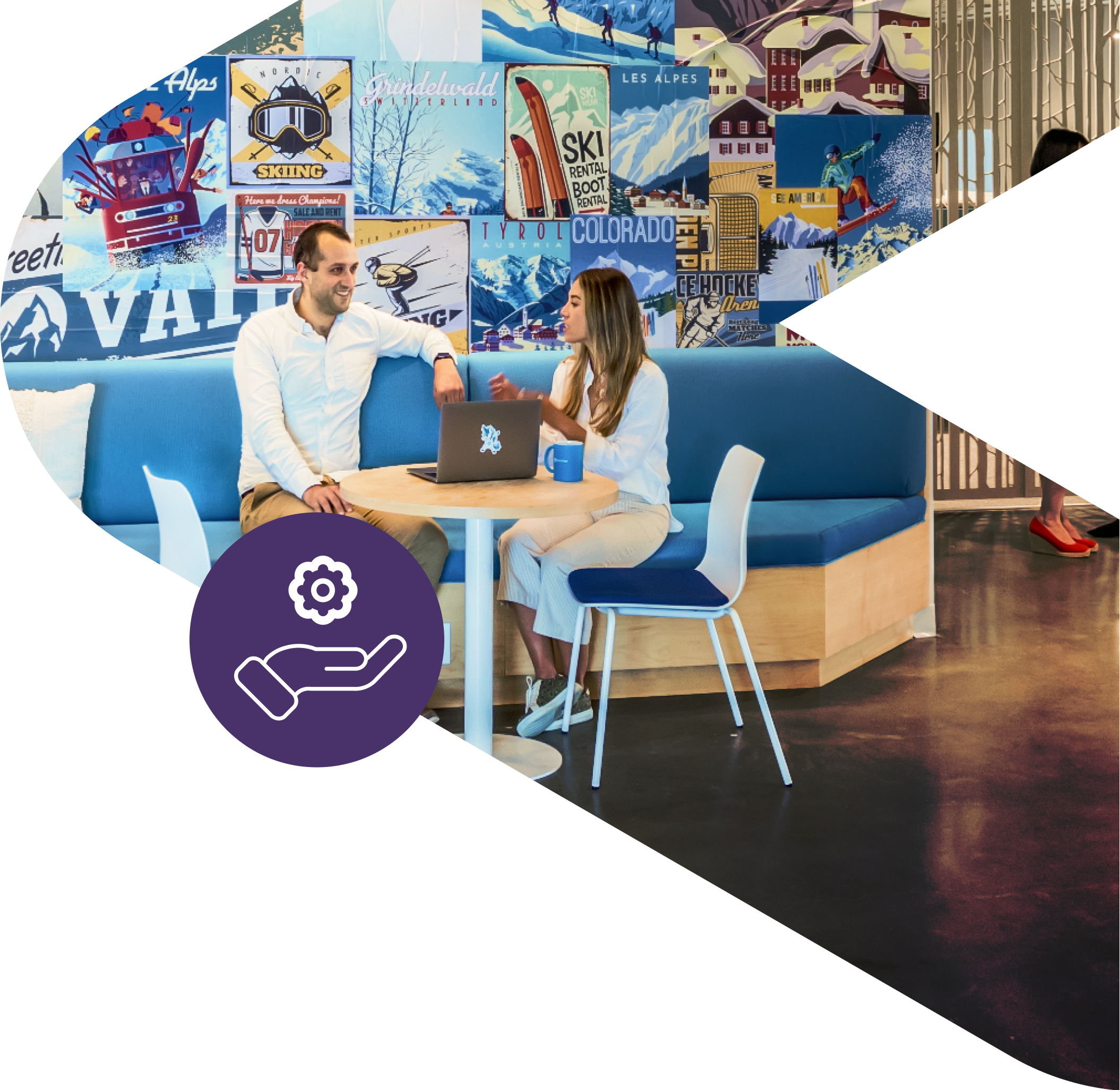 Two people speaking sitting on a couch in the office