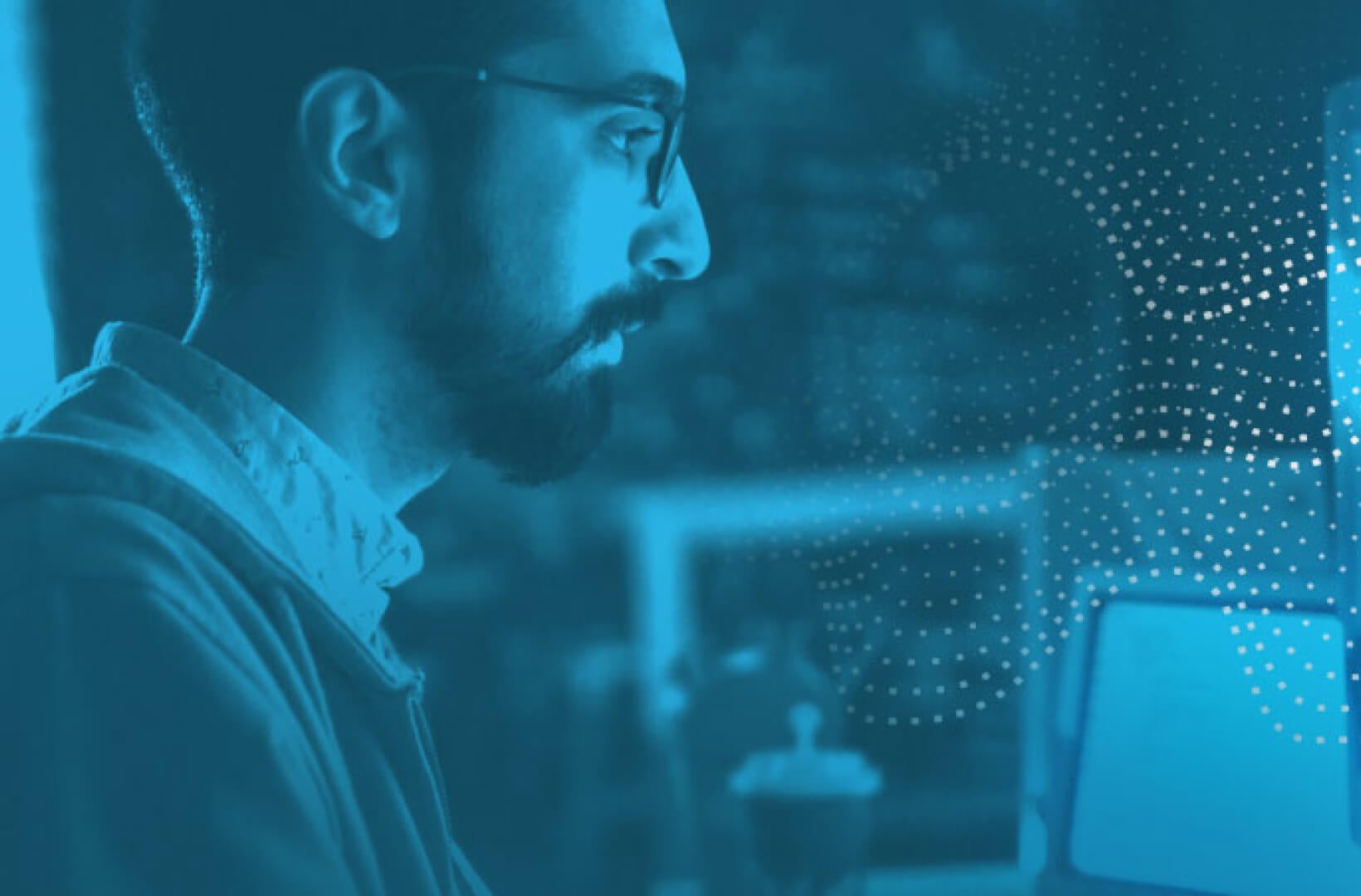  Stock image of man using computer with blue overlay and dotted pattern