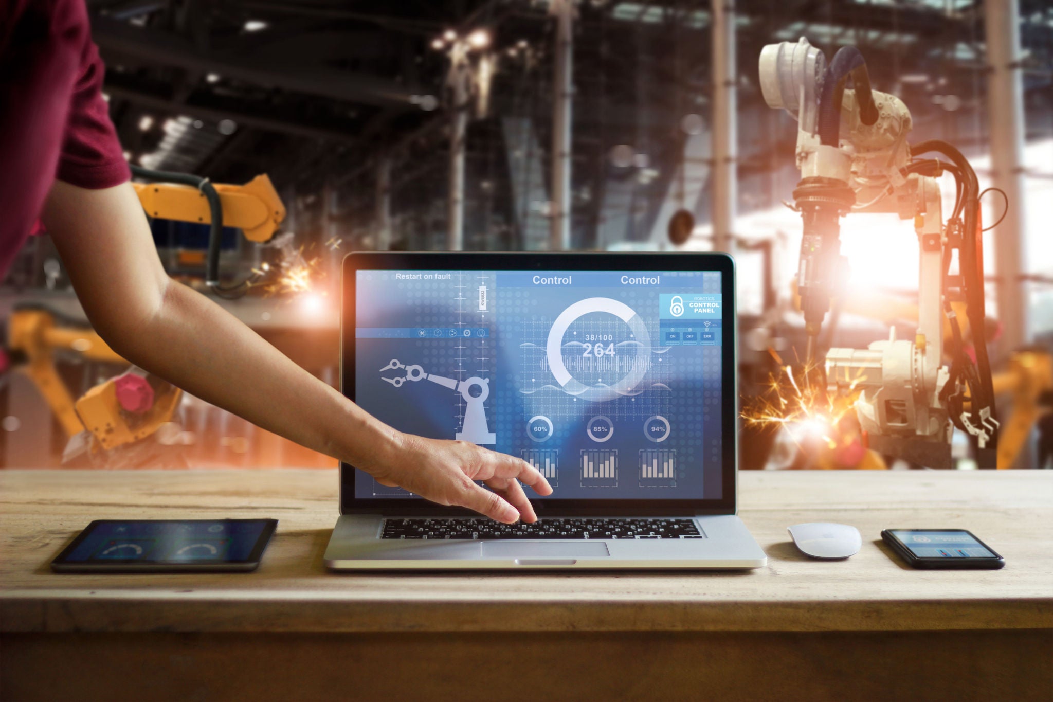 Laptop set up in front of manufacturing equipment