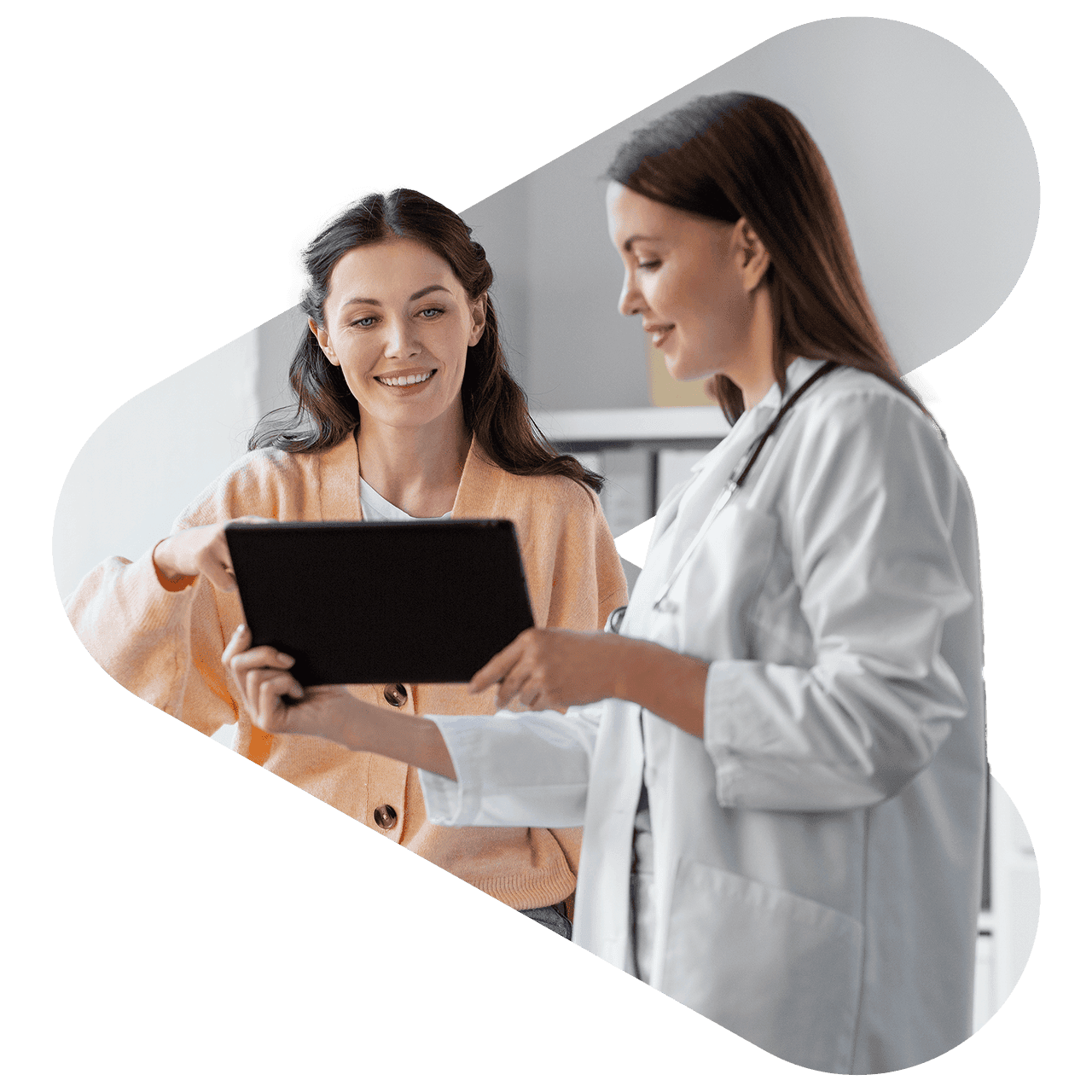 A doctor and a patient viewing medical exam results on a tablet