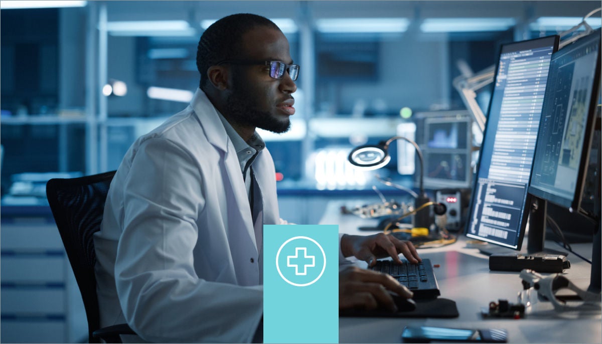 Healthcare worker in front of a computer in a lab