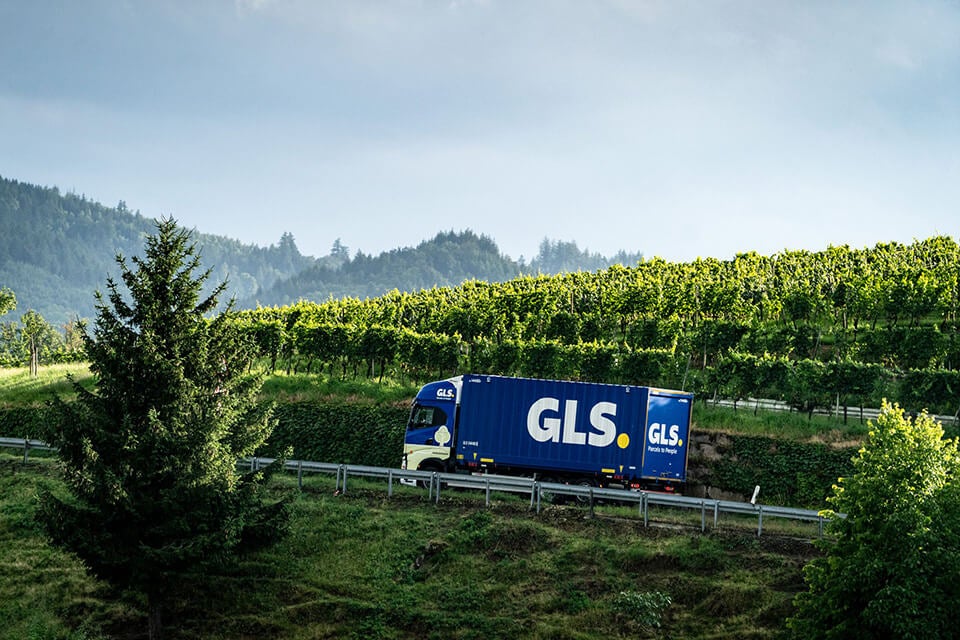 GLS truck driving through the green hills