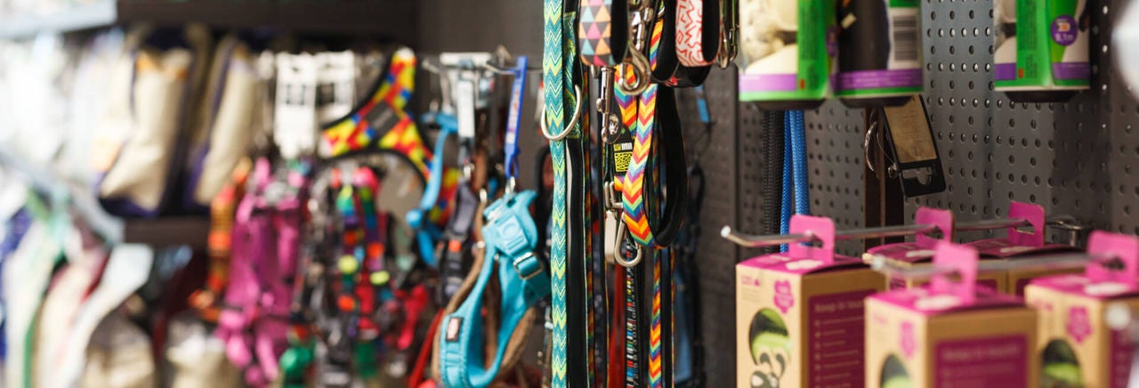 Employees looking at a series of network connections on a map of the world on a screen
