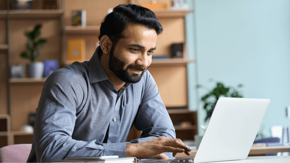 man using laptop to watch webinar
