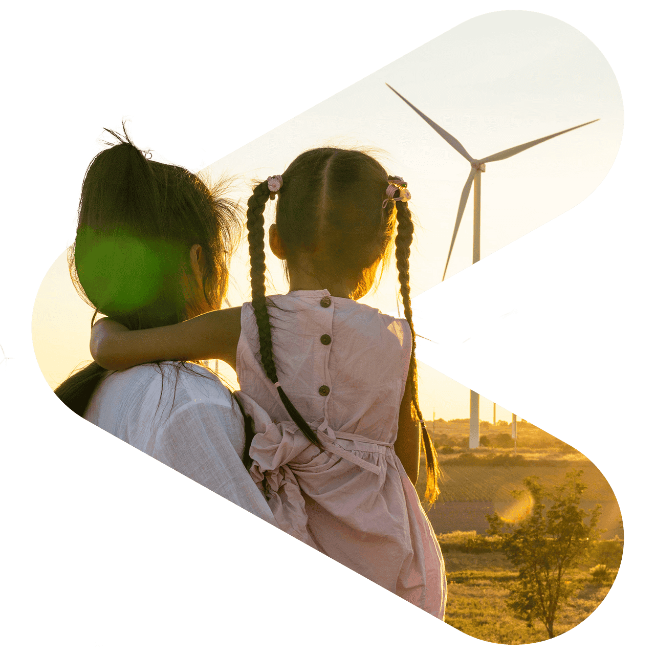 A mother and daughter looking away from the camera at a wind turbine