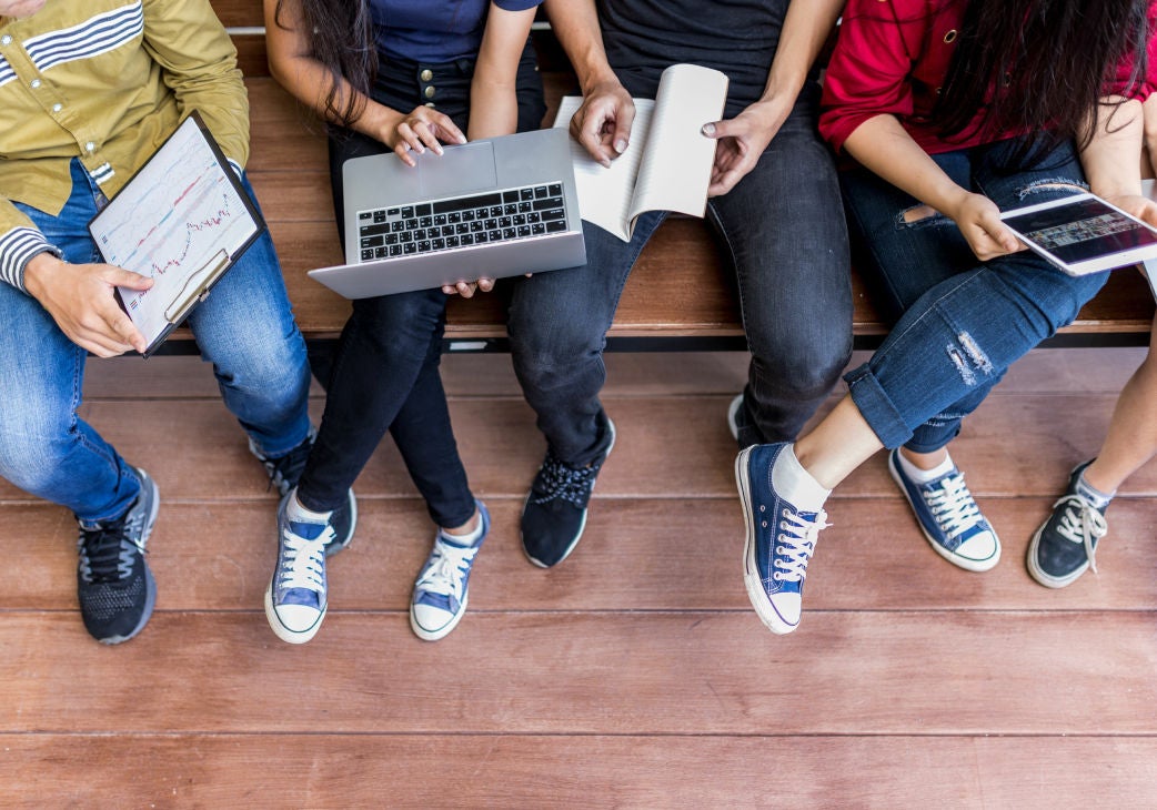 top down image of students using laptops