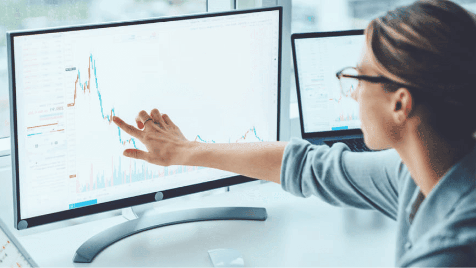 woman looking through data on computer