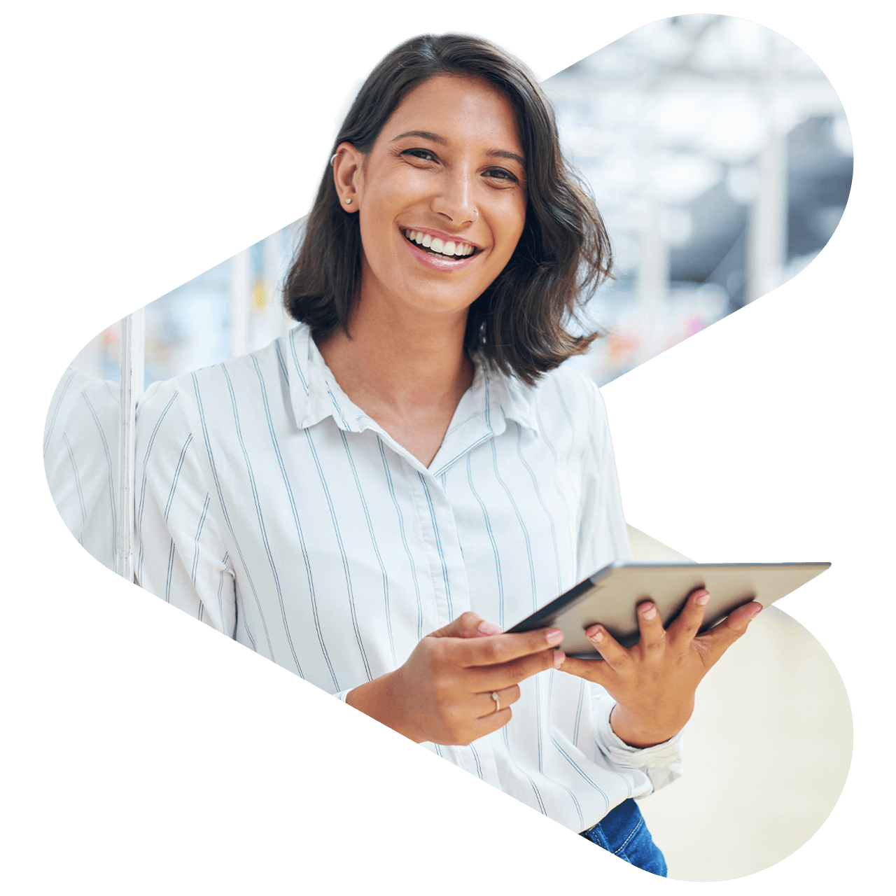 woman wearing a white and blue striped collared button down shirt while smiling and holding a tablet in her hands