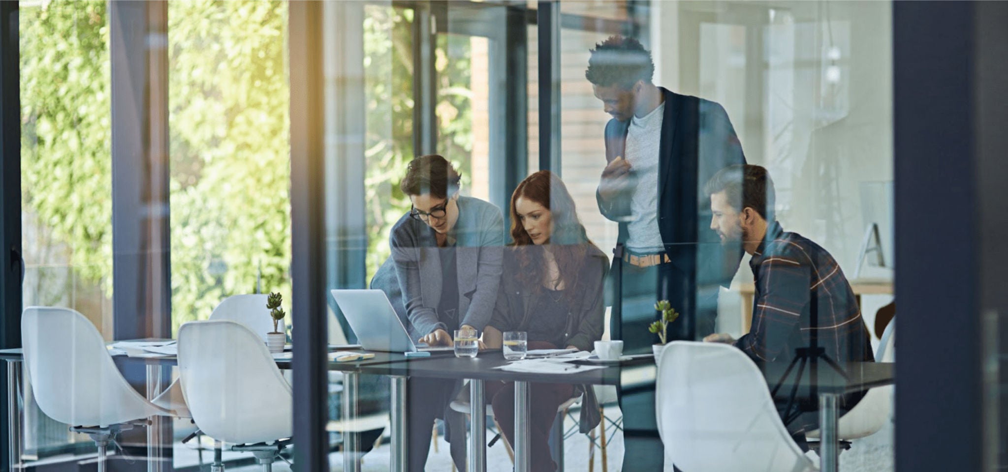 Team working around a computer in an office