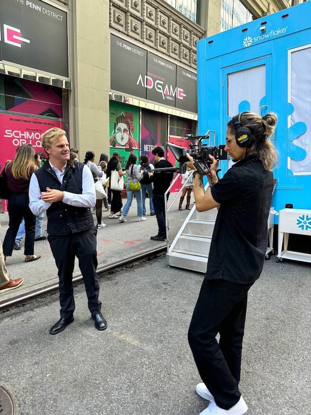 Ryan Green of Data Cloud Now films an epsiode in the street outside of AdWeek 2024