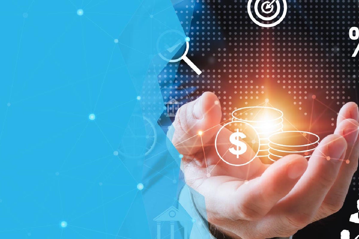 Close up of hand holding graphic of glowing pile of coins.