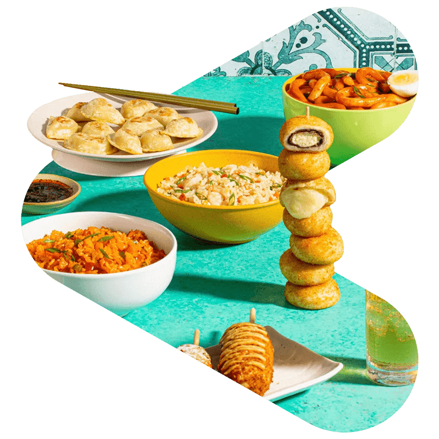 korean woman eating while holding a spoon and fork