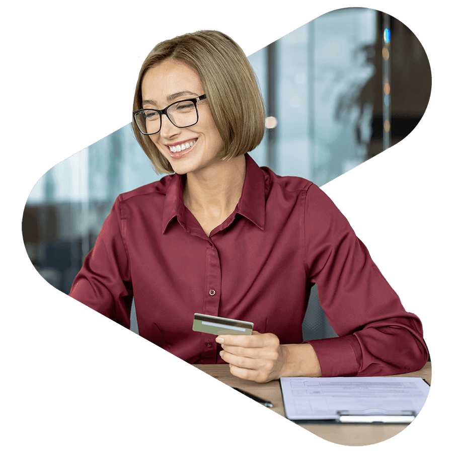 financial services worker smiling while holding a credit card