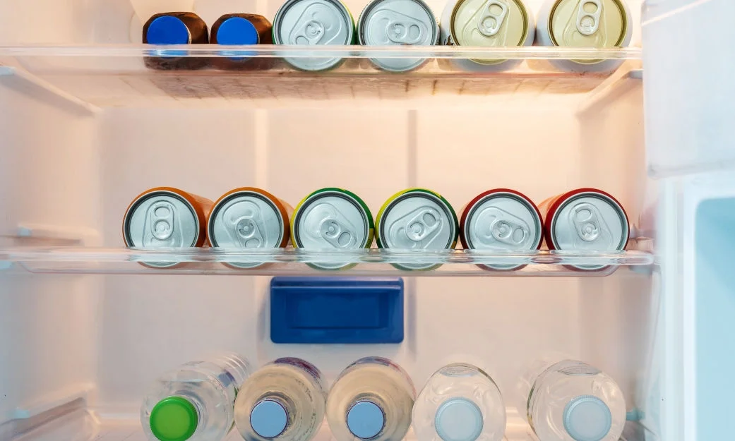 canned drinks laying down in a refrigerator