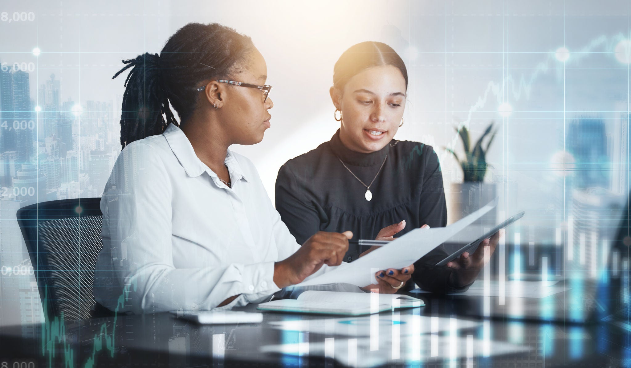 Digital, documents and collaboration with a business team working together in an office for future growth. Data, finance and teamwork with a female employee and colleague talking while reading paper.