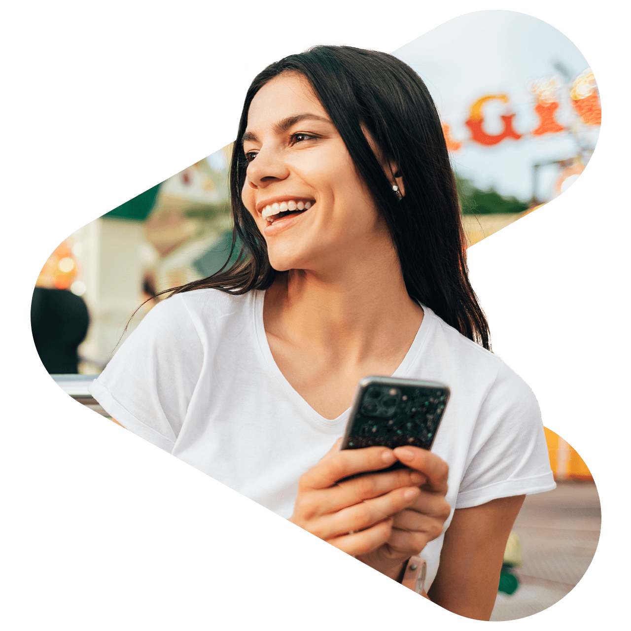 woman at disney wearing a white vneck shirt holding her iphone