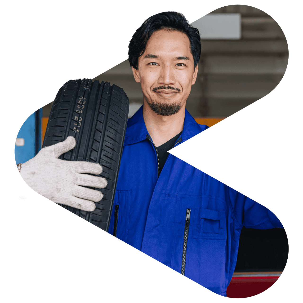 tire shop worker holding tire