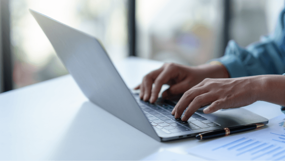 persons hands using computer