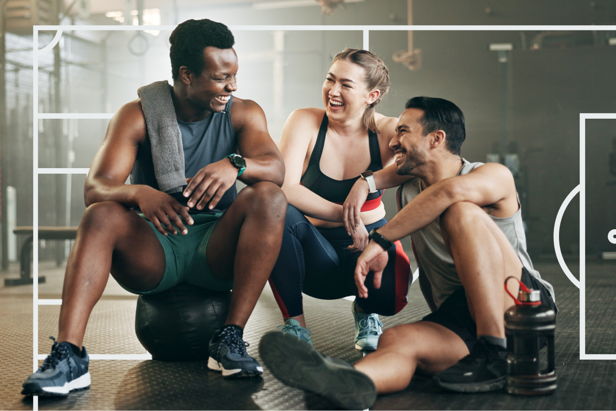 Athletes laughing together in a gym